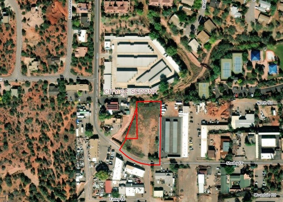 Aerial view of the 2250 Shelby Drive parcel in Sedona, outlined in red, between industrial and storage buildings